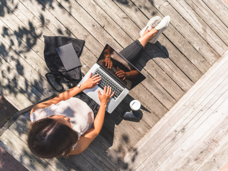 A person sitting outside while working from home