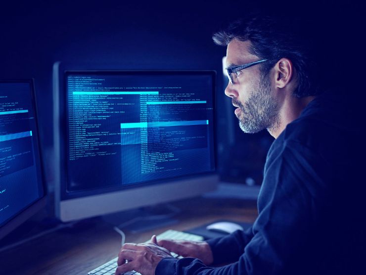 Man in front of monitors