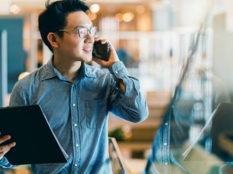 Business professional walking with a laptop