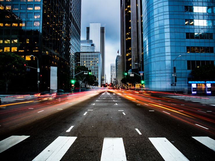 A city street at twilight with cars blurred in the background