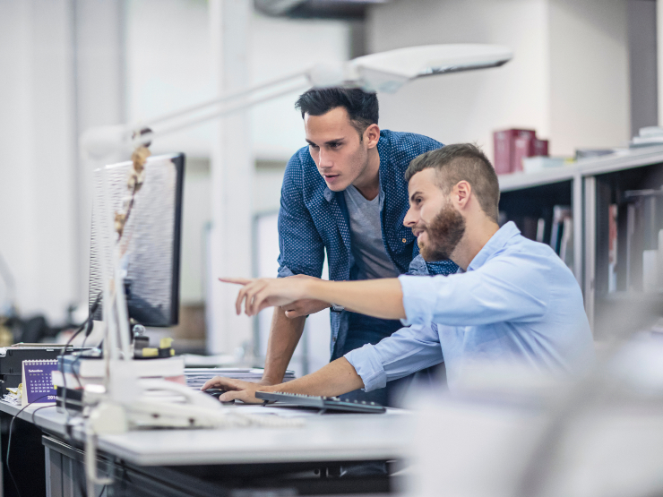 Two men looking at a monitor