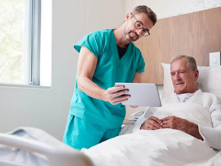 A doctor and patient looking at a device