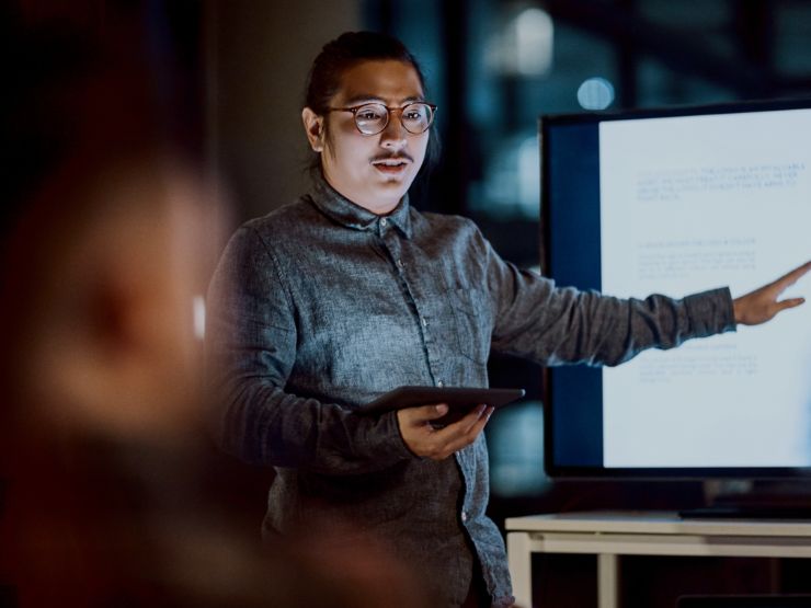 Man standing at a screen presenting