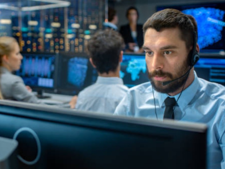 Man working on security interface multiple screens