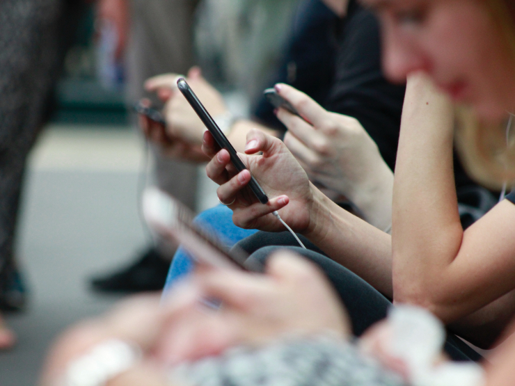 Business professionals looking at mobile apps