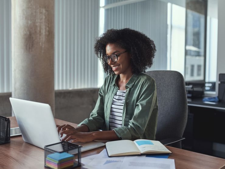 Lady in a green jersey typing
