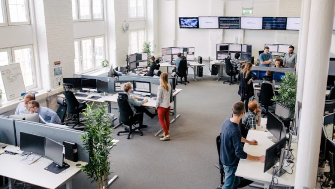 People sitting and standing in an open-plan office