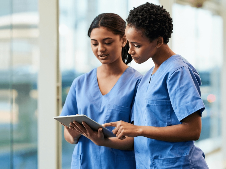 Healthcare professionals holding a tablet